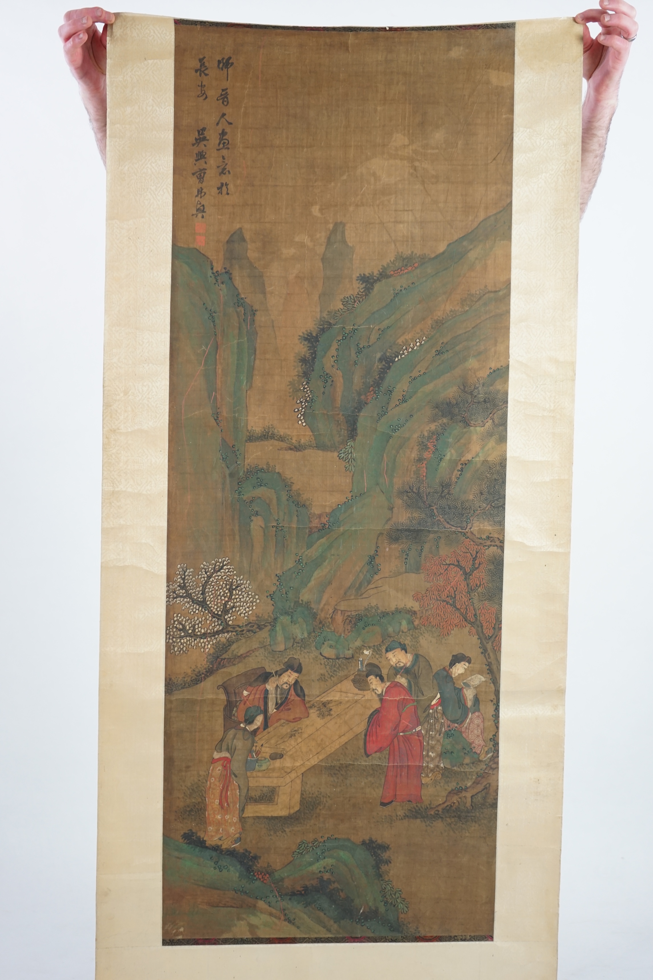 Chinese School, 19th century, scroll painting, ink and colour on silk, scholars in a garden examining a painting